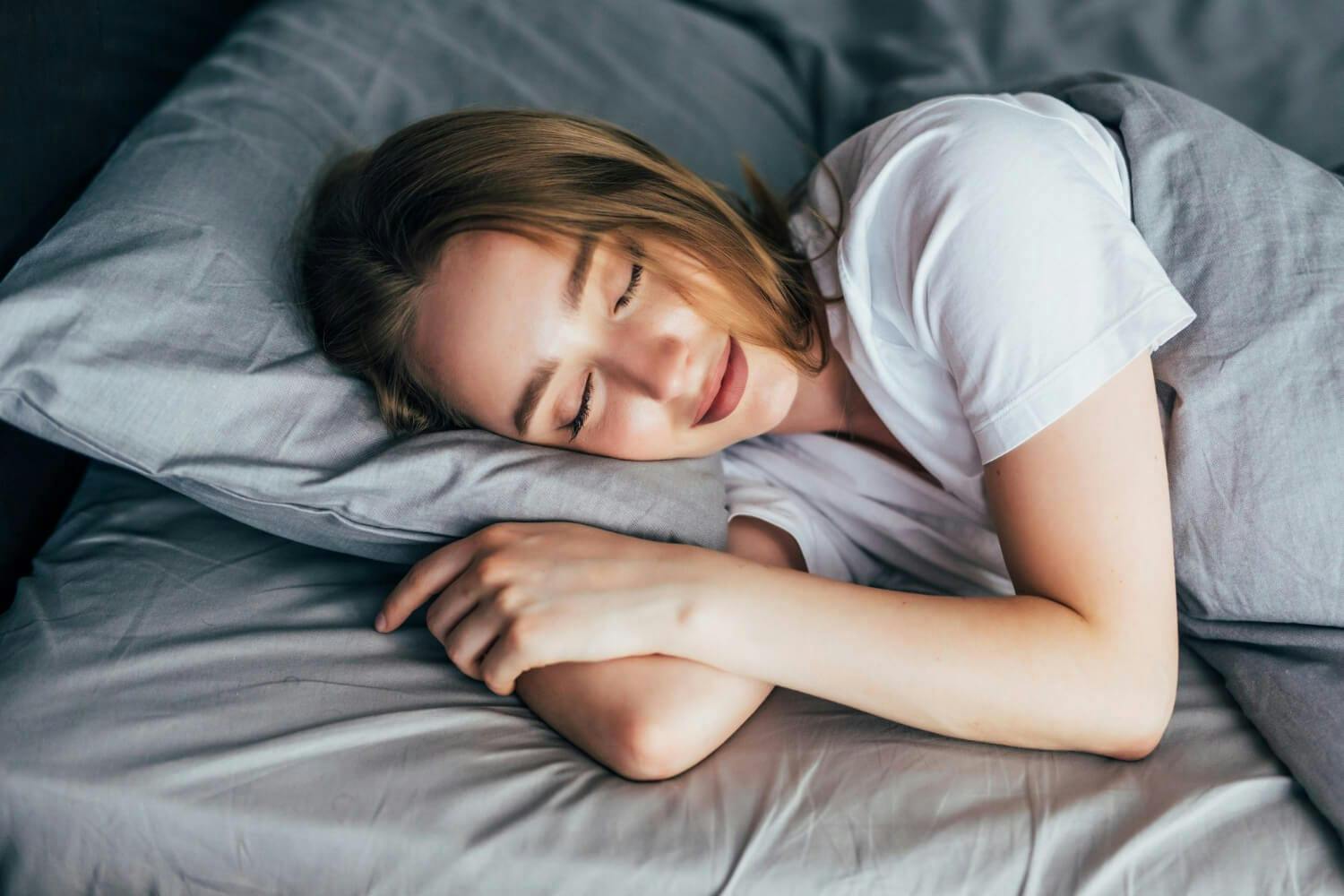 how to overcome overthinking at night a lady is taking a sound sleep with happy face 