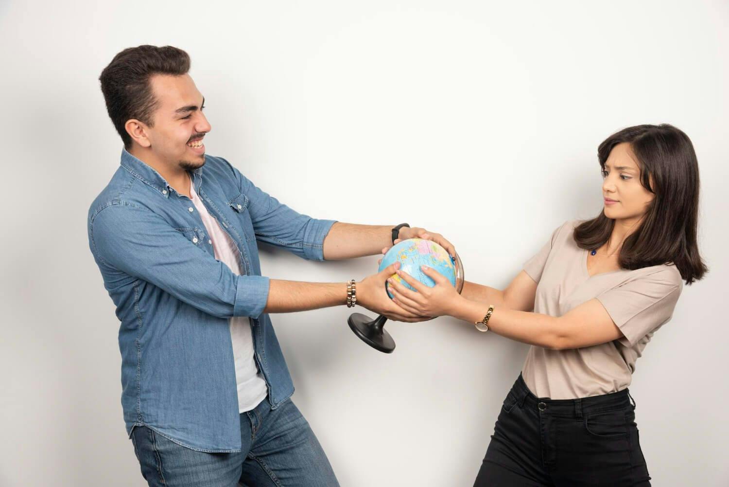 Picture of man and woman holding earth globe and Improve Relationships Without Leaving Someone with OCPD