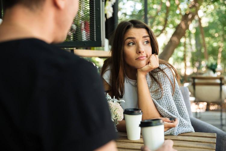 a couple sat on a table but a lady starts overthinking about their relationship and about someone