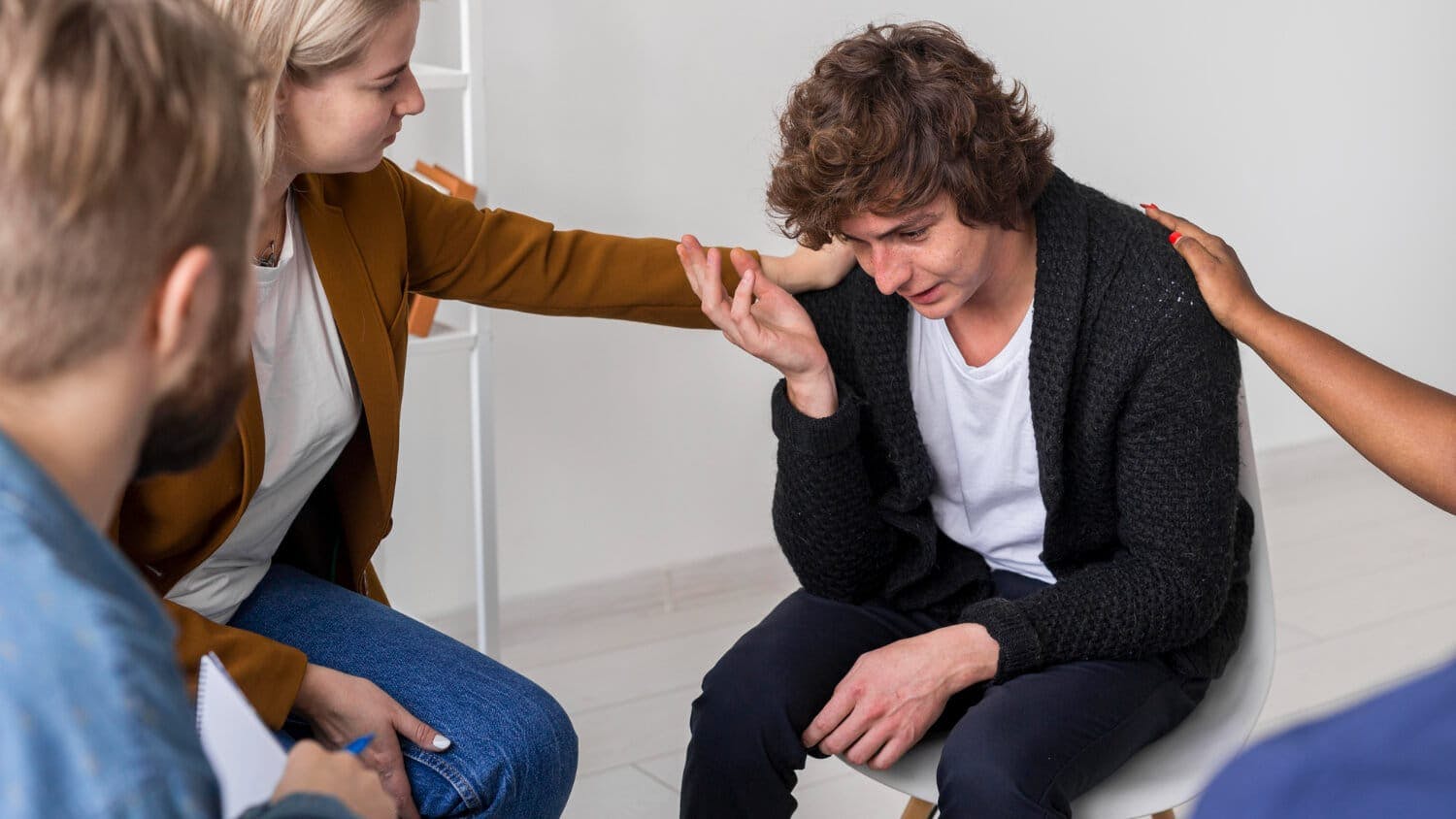 Community helping sad and panic attacked man close-up