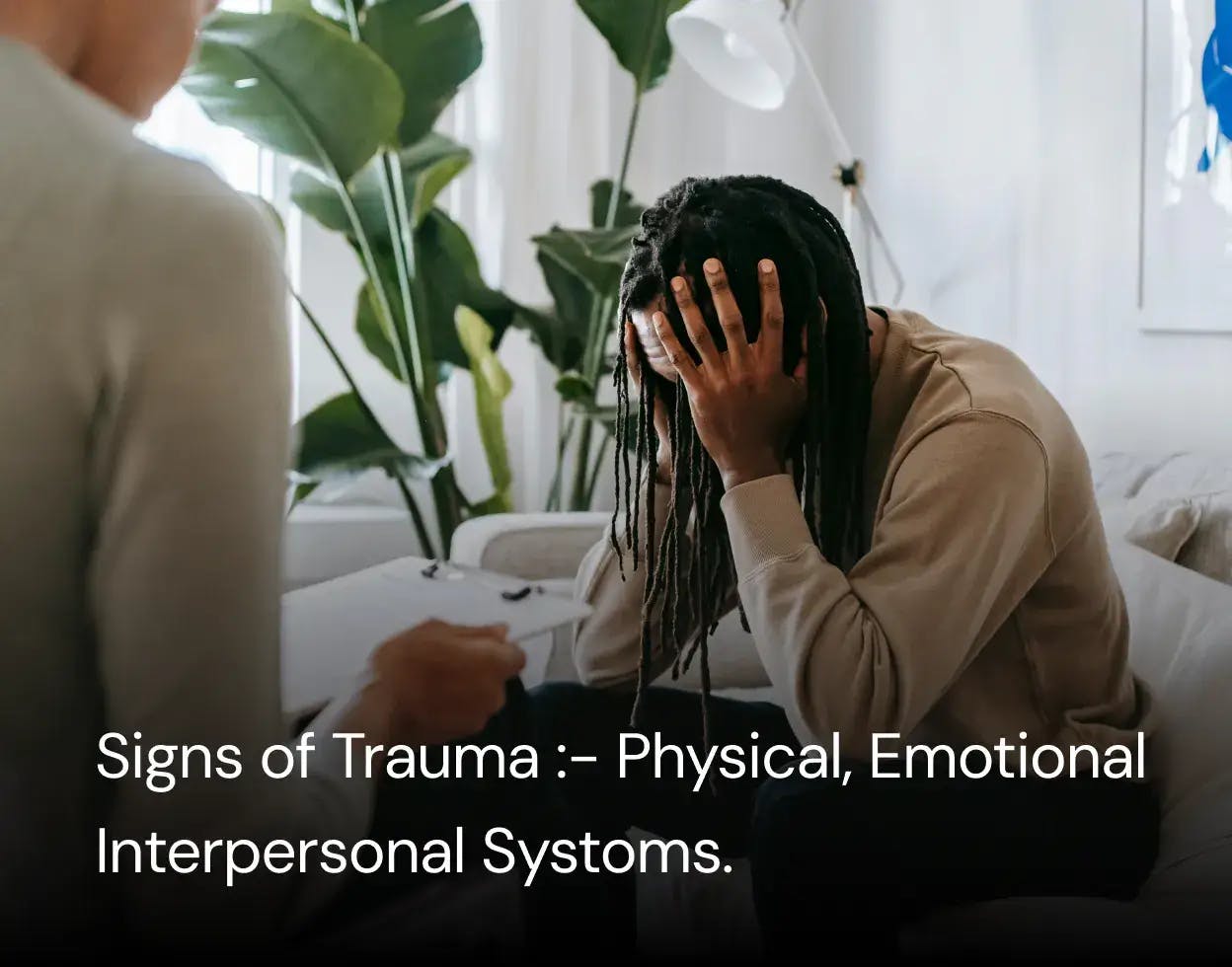 What is Trauma - a person with a hands on head sitting with therapist