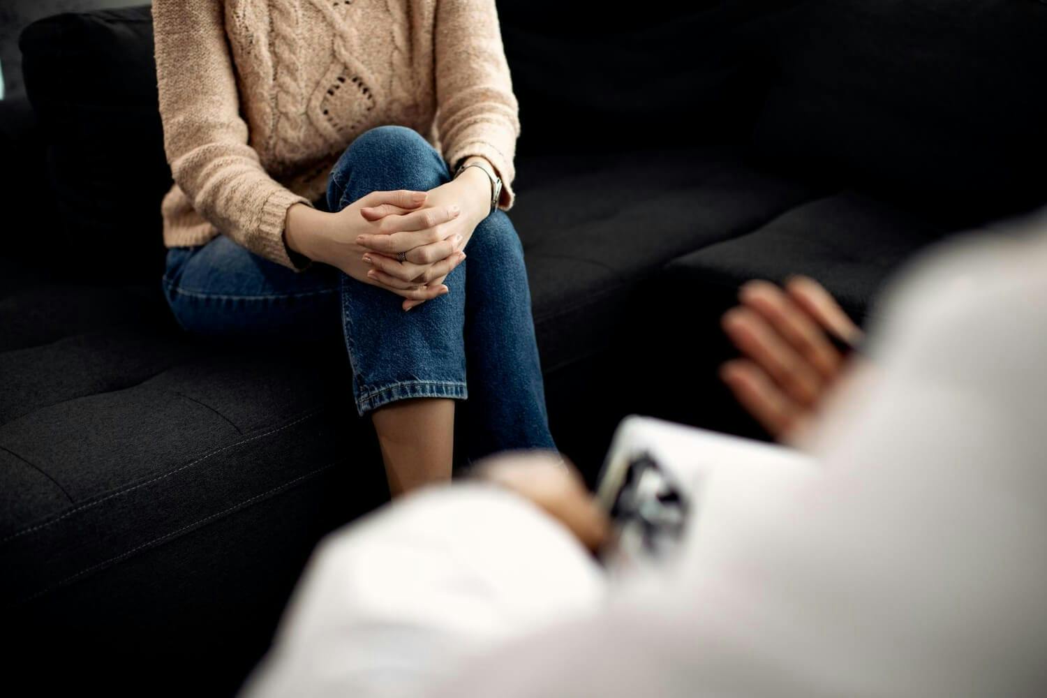 woman during counseling with mental health professional for treatment of anxiety