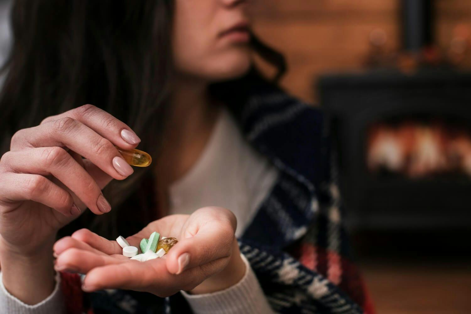 Close-up woman holding antidepressants medicine in her hand