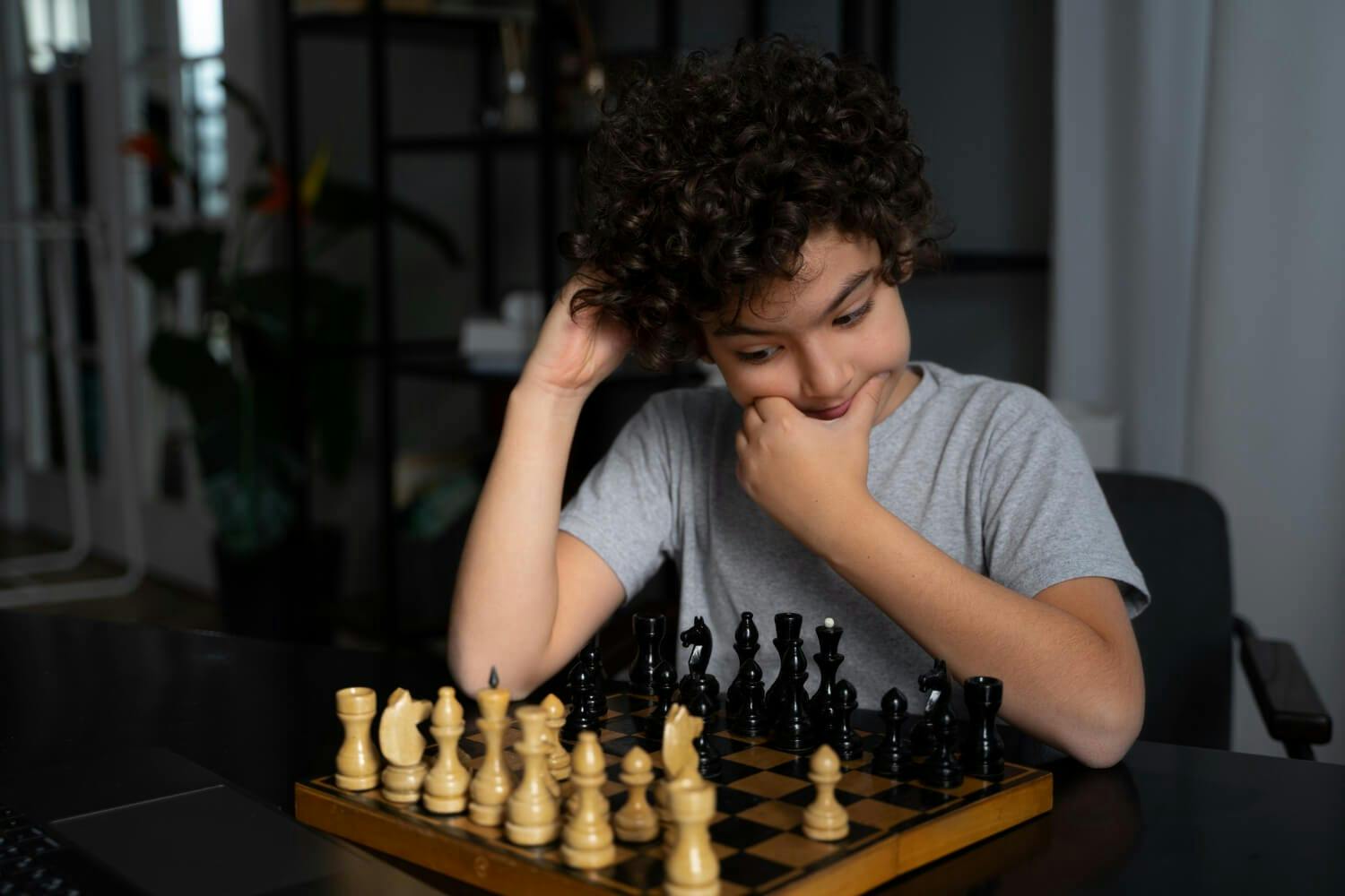 Young kid playing chess - brain exercise