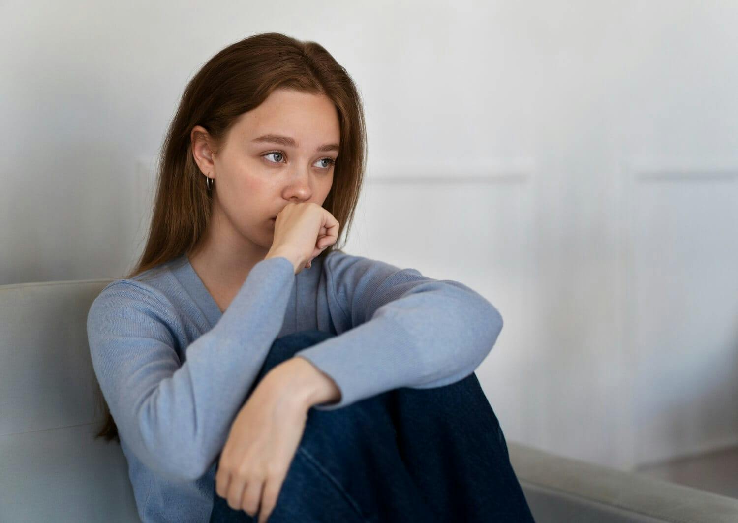 a young lady sat with. disappointment with shaking body because of anxiety